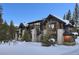 Stunning exterior of a luxury home in a snowy mountain setting at 104 Penn Lode Dr, Breckenridge, CO 80424