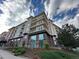 Multi-story brick apartment building with landscaping and a green lawn at 10111 Inverness Main St # 223, Englewood, CO 80112