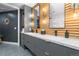 Modern bathroom with double vanity and wood feature wall at 333 S Monroe St # 211, Denver, CO 80209