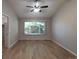 Large bedroom with hardwood floors and a large window at 6475 Orion Way, Arvada, CO 80007