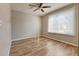 Spacious bedroom with wood-look floors and ceiling fan at 6475 Orion Way, Arvada, CO 80007