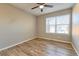 Bright bedroom featuring wood-look flooring and large window at 6475 Orion Way, Arvada, CO 80007