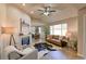 Spacious living room with a fireplace, hardwood floors, and large windows at 6475 Orion Way, Arvada, CO 80007
