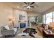 Spacious living room with a fireplace, hardwood floors, and large windows at 6475 Orion Way, Arvada, CO 80007