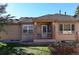 Back patio with brick columns and a small yard at 6475 Orion Way, Arvada, CO 80007