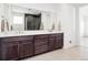 Modern bathroom with double vanity, large mirror, and hexagon tile shower at 3051 Newfound Lake Rd, Berthoud, CO 80513