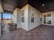 Covered patio with wood-look tile flooring, neutral color scheme, and sliding glass door access at 3051 Newfound Lake Rd, Berthoud, CO 80513