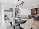 Bright dining room features a large table and modern chandelier at 3051 Newfound Lake Rd, Berthoud, CO 80513