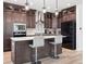 Modern kitchen with dark cabinets and large island at 3051 Newfound Lake Rd, Berthoud, CO 80513