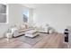 Spacious living room with L-shaped sectional sofa and hardwood floors at 3051 Newfound Lake Rd, Berthoud, CO 80513