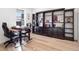 Home office with a standing desk and extensive built-in shelving at 3051 Newfound Lake Rd, Berthoud, CO 80513