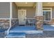 Front porch with stone accents, a sitting area, and a welcoming entrance at 17909 E 103Rd Ave, Commerce City, CO 80022