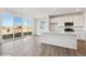 Modern kitchen with island, white cabinets and sliding glass doors at 4591 Boone Cir, Brighton, CO 80601