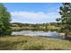 Serene community lake with scenic reflections and landscaping at 5069 Castle Pines S Dr, Castle Rock, CO 80108