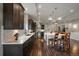 Modern kitchen with dark cabinetry, large island, and stainless steel appliances at 5069 Castle Pines S Dr, Castle Rock, CO 80108