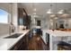 Modern kitchen with white quartz countertops and dark wood cabinets at 5069 Castle Pines S Dr, Castle Rock, CO 80108