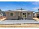 Rear view of a single-story home with a sliding glass door and snowy yard at 24513 E 36Th Ave, Aurora, CO 80019