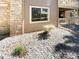 Building exterior showcasing stone accents and landscaping at 10243 E Peakview Ave # A103, Englewood, CO 80111