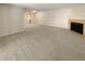 Spacious living room with fireplace and view into kitchen area at 10243 E Peakview Ave # A103, Englewood, CO 80111