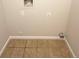 Small laundry room with tile floor and hookups for washer and dryer at 10243 E Peakview Ave # A103, Englewood, CO 80111