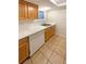 Kitchenette with wood cabinets, white appliances, and speckled countertops at 10243 E Peakview Ave # A103, Englewood, CO 80111