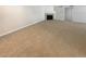 Spacious living room featuring a cozy fireplace and neutral carpeting at 10243 E Peakview Ave # A103, Englewood, CO 80111