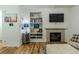 Comfortable living room with built-in shelving and a gas fireplace at 9551 Longford Way, Parker, CO 80134