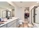 Modern bathroom with walk-in shower, soaking tub and double vanity at 17847 E 95Th Ave, Commerce City, CO 80022