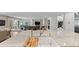 Modern kitchen boasts expansive island with sink and breakfast bar at 560 Front Range Rd, Littleton, CO 80120