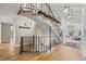 Stunning curved staircase with wrought iron railing and hardwood flooring at 560 Front Range Rd, Littleton, CO 80120