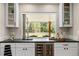 Kitchen features a pass-through window to backyard and wine cooler at 560 Front Range Rd, Littleton, CO 80120