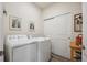 Bright laundry room with washer, dryer, and ample storage at 101 Ambrose St, Erie, CO 80516