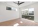 Bright bedroom with ceiling fan, large window, and light hardwood floors at 1283 Meade St, Denver, CO 80204