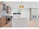 Modern kitchen with a breakfast bar and white quartz countertops at 1283 Meade St, Denver, CO 80204