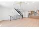 Light-filled living area with hardwood floors and modern staircase at 1283 Meade St, Denver, CO 80204