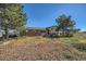 Brick ranch home with a red door and large yard at 2452 Shetland Trl, Elizabeth, CO 80107