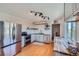 Modern kitchen featuring stainless steel appliances and light wood flooring at 2452 Shetland Trl, Elizabeth, CO 80107