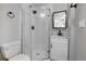 Updated bathroom with a walk-in shower and white vanity at 2103 S Lafayette St, Denver, CO 80210