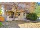 House exterior showcasing front porch and mature tree at 2103 S Lafayette St, Denver, CO 80210