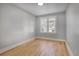 Spacious bedroom with hardwood floors and two windows at 2103 S Lafayette St, Denver, CO 80210