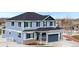 Two-story home with light blue siding, navy blue shutters, and a two-car garage at 941 Saint Andrews Ln, Louisville, CO 80027