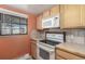Kitchen with white appliances and wood cabinets at 1021 Carr St # 22, Lakewood, CO 80214