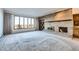 Living room features a brick fireplace and expansive windows at 6936 S Chapparal Cir, Aurora, CO 80016