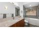 Modern bathroom with a soaking tub, shower, and granite vanity at 4497 Independence Trl, Evergreen, CO 80439