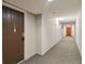 Condo hallway with carpeted floors and neutral-colored walls at 3460 S Poplar St # 307, Denver, CO 80224
