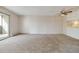Bright living room with carpet flooring and sliding glass door to balcony at 3460 S Poplar St # 307, Denver, CO 80224