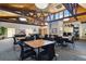 Community room with tables, chairs, and a bar area at 3460 S Poplar St # 307, Denver, CO 80224
