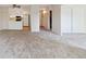 Condo living room with an open floor plan, carpet, and kitchen access at 3460 S Poplar St # 307, Denver, CO 80224