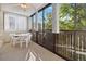 Bright sunroom with table and chairs, offering treetop views at 3460 S Poplar St # 307, Denver, CO 80224