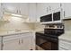 View of kitchen sink, stovetop, and microwave at 3460 S Poplar St # 307, Denver, CO 80224